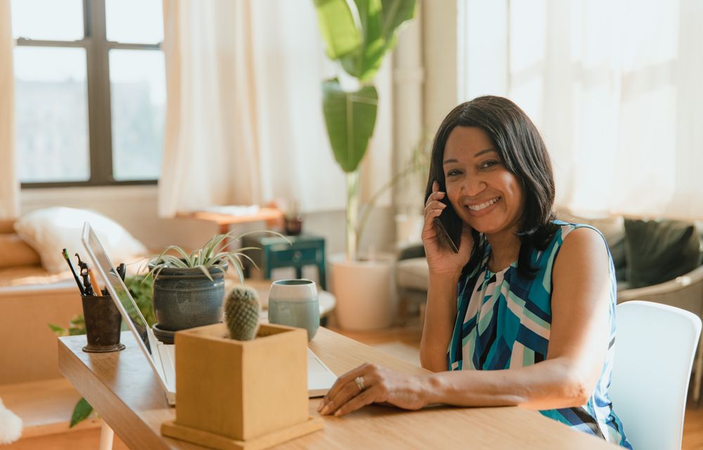 A small-business owner on a call at her desk
